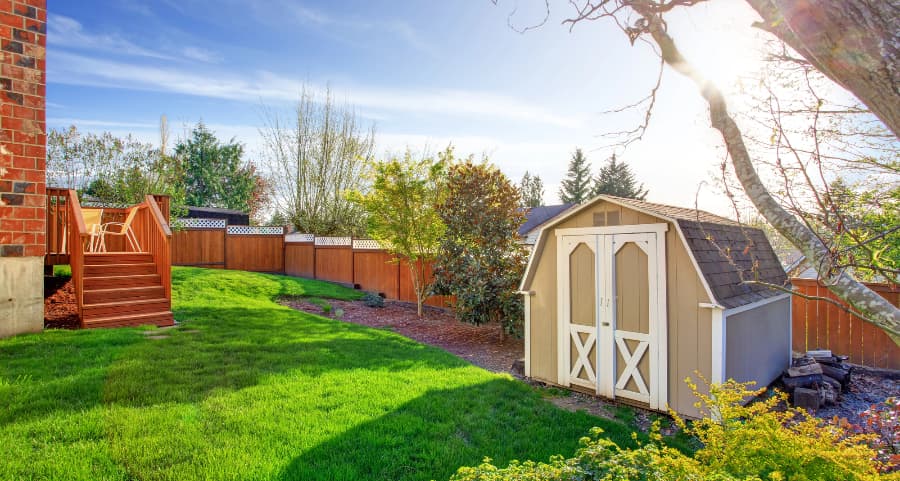 Fenced backyard with storage shed in Athens